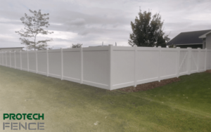 A professionally installed white vinyl fence by Protech Fence, showcasing quality craftsmanship and security, representing one of the top fence companies in Ammon, ID.