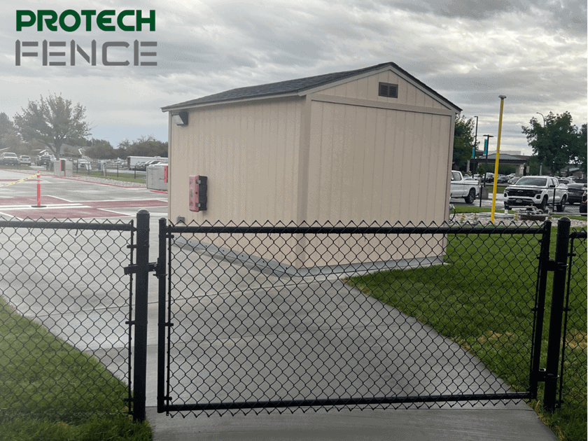 A black chain-link gate installed by Protech Fence, providing secure access and durability, representing expert residential and commercial fencing solutions in Ammon, ID
