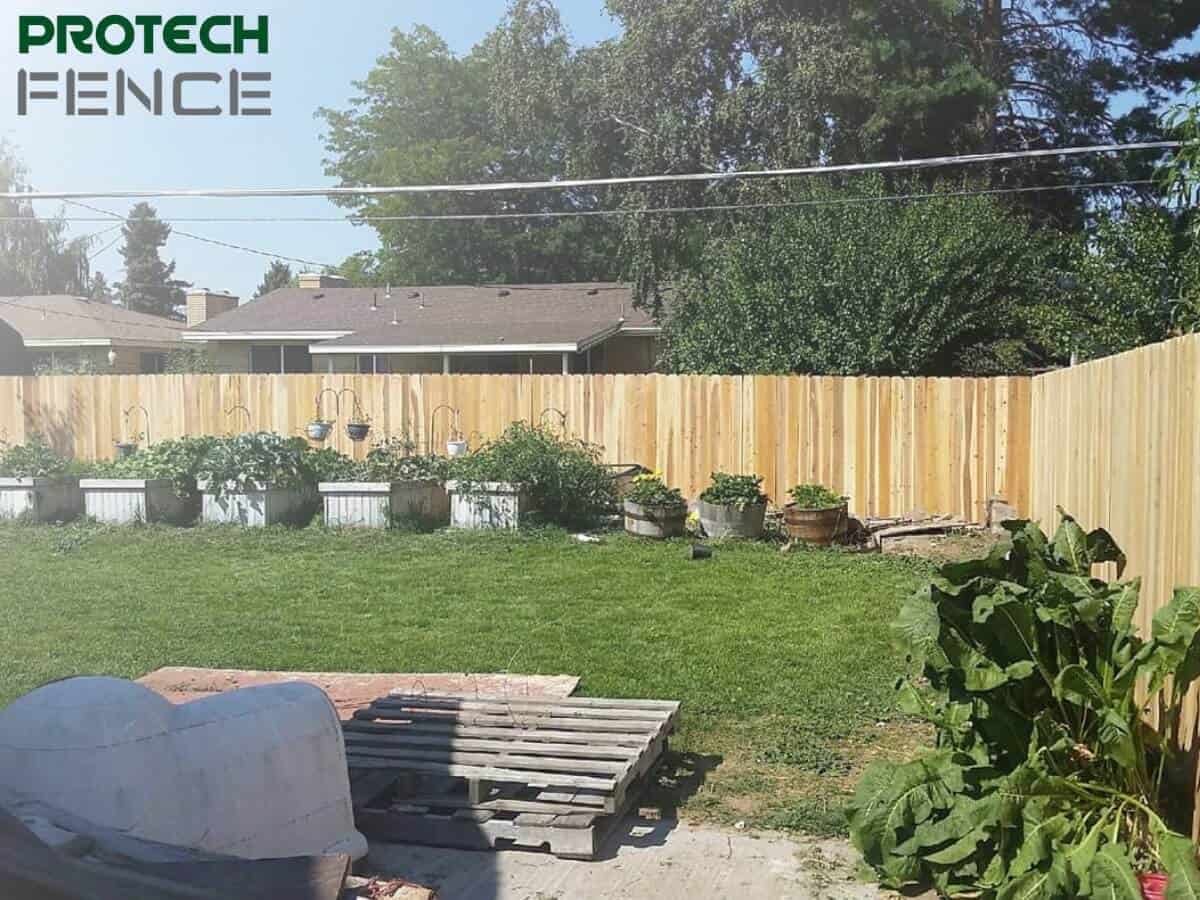 Backyard view featuring a newly installed wood fence by local wood fence gate installers near me, highlighting the craftsmanship and secure privacy provided by the fence.
